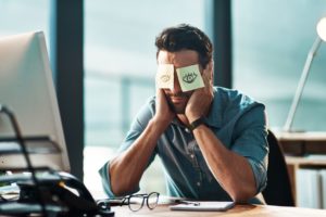 Man with post it notes on face with drawn on eyes